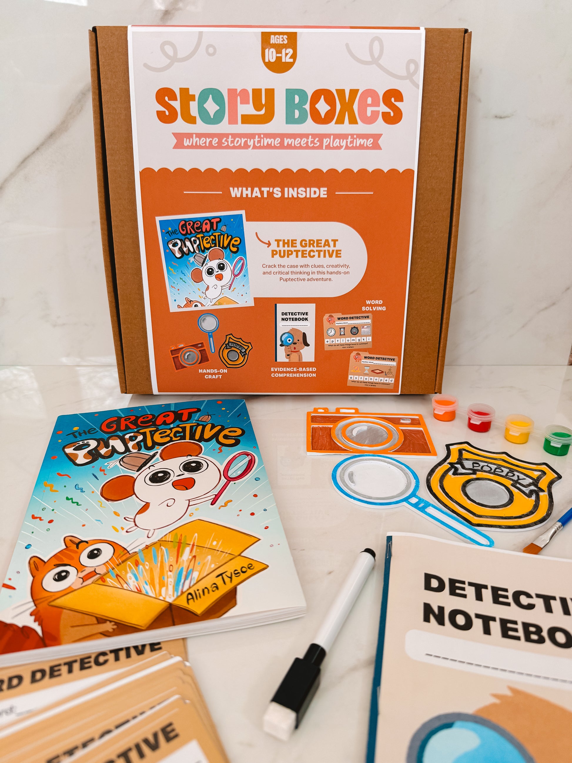 Story Boxes educational kit with books and stationery on a white surface