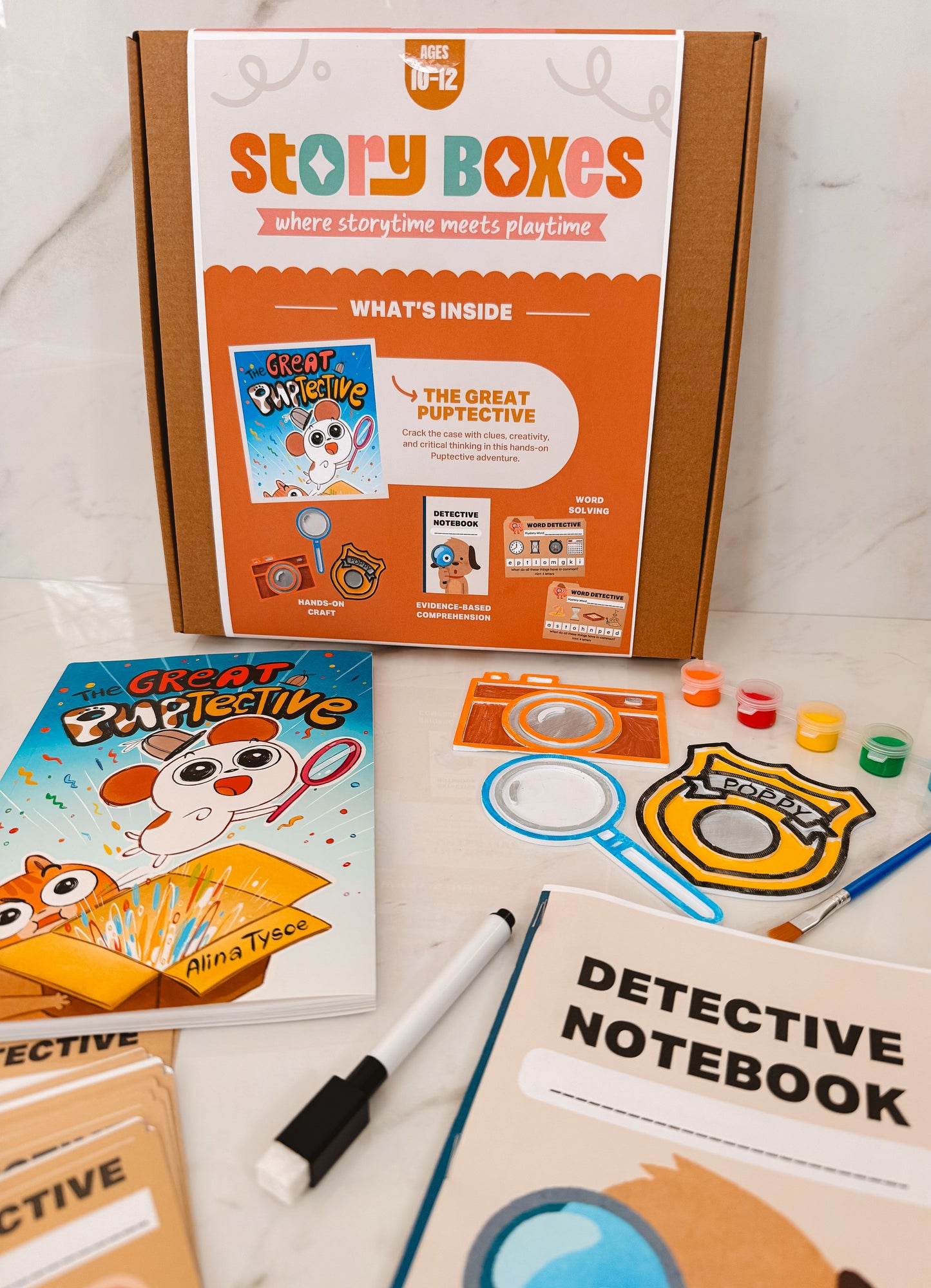 Storytime kit with 'Great Pupective' book, detective notebook, and props on a white surface.
