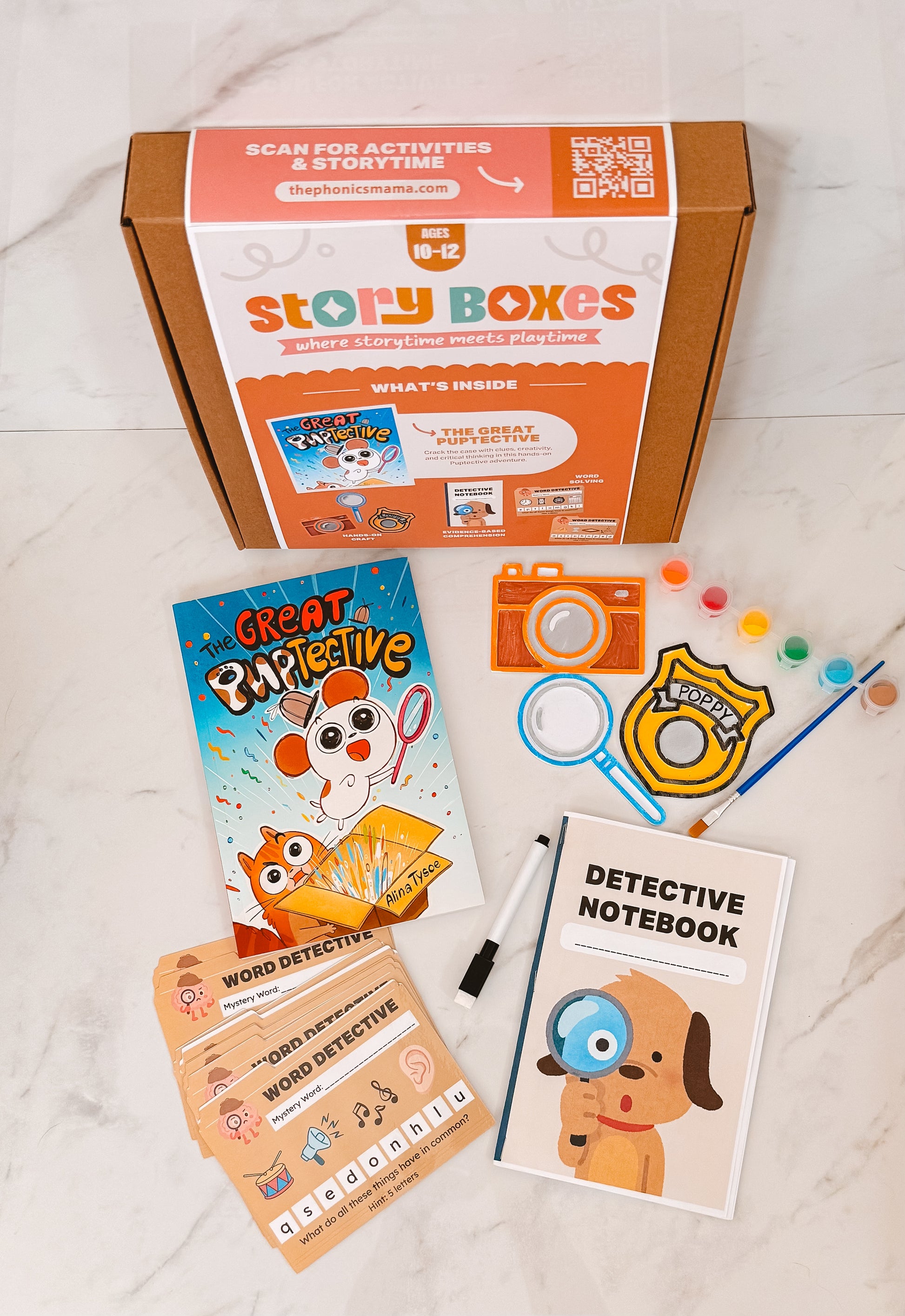 Story Boxes educational kit with books, notebook, and props on a light surface