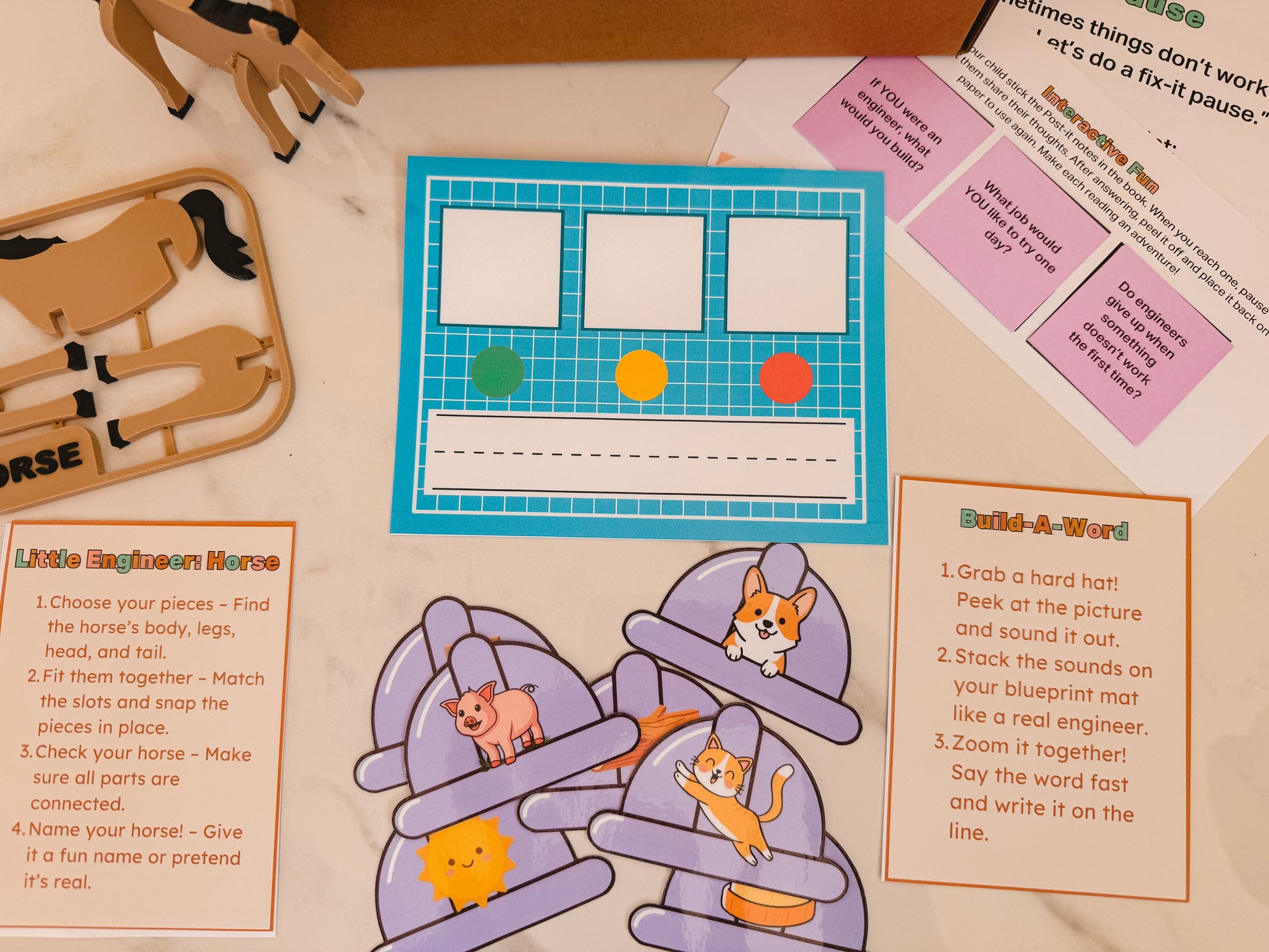 Educational materials including a horse model, coloring sheets, and activity cards on a table.