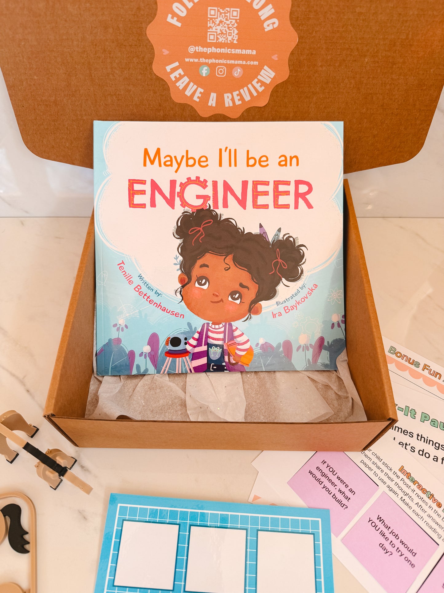 Children's book titled 'Maybe I'll be an Engineer' in a box with educational materials.