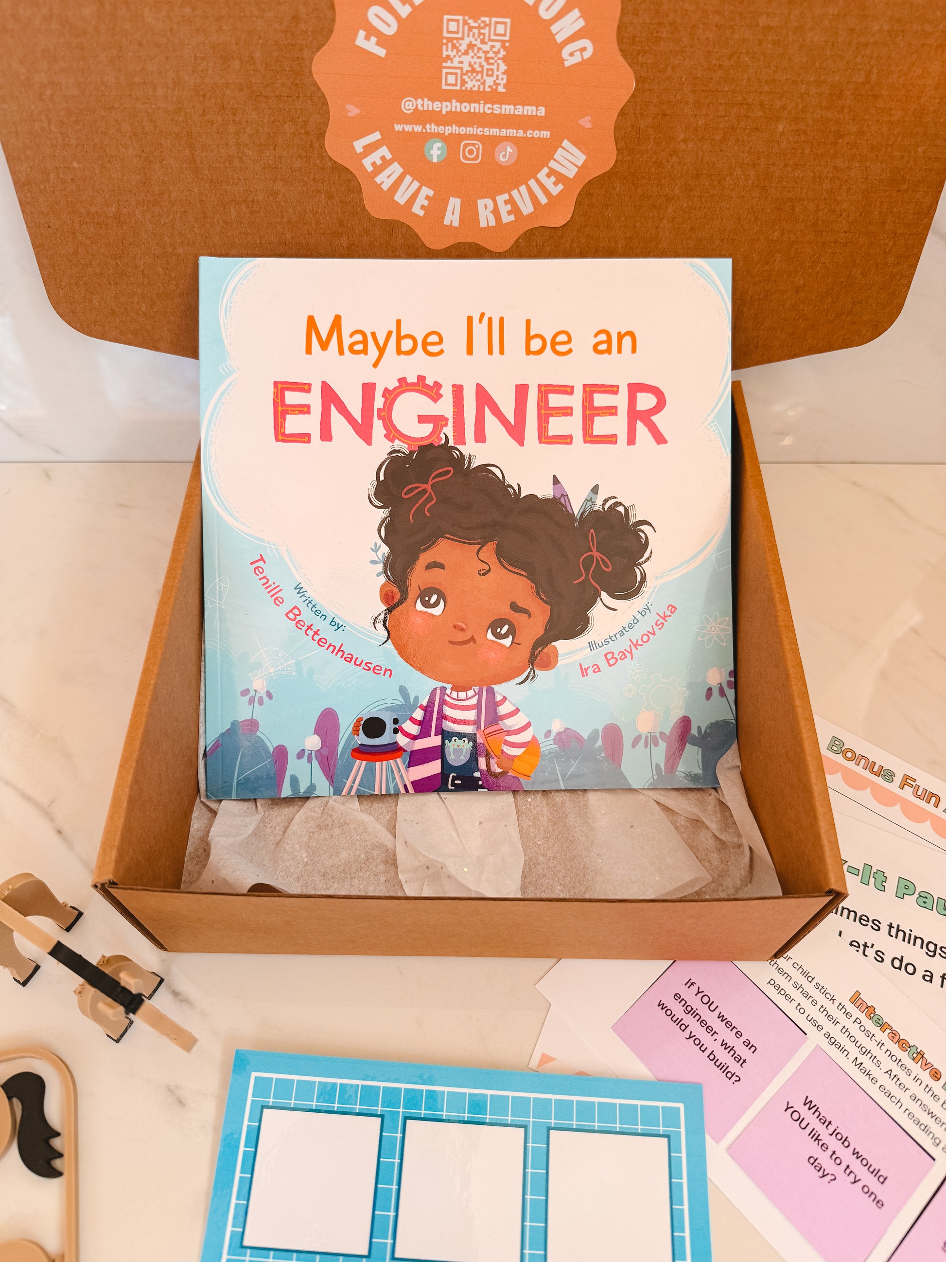 Children's book titled 'Maybe I'll be an Engineer' in a box with educational materials.