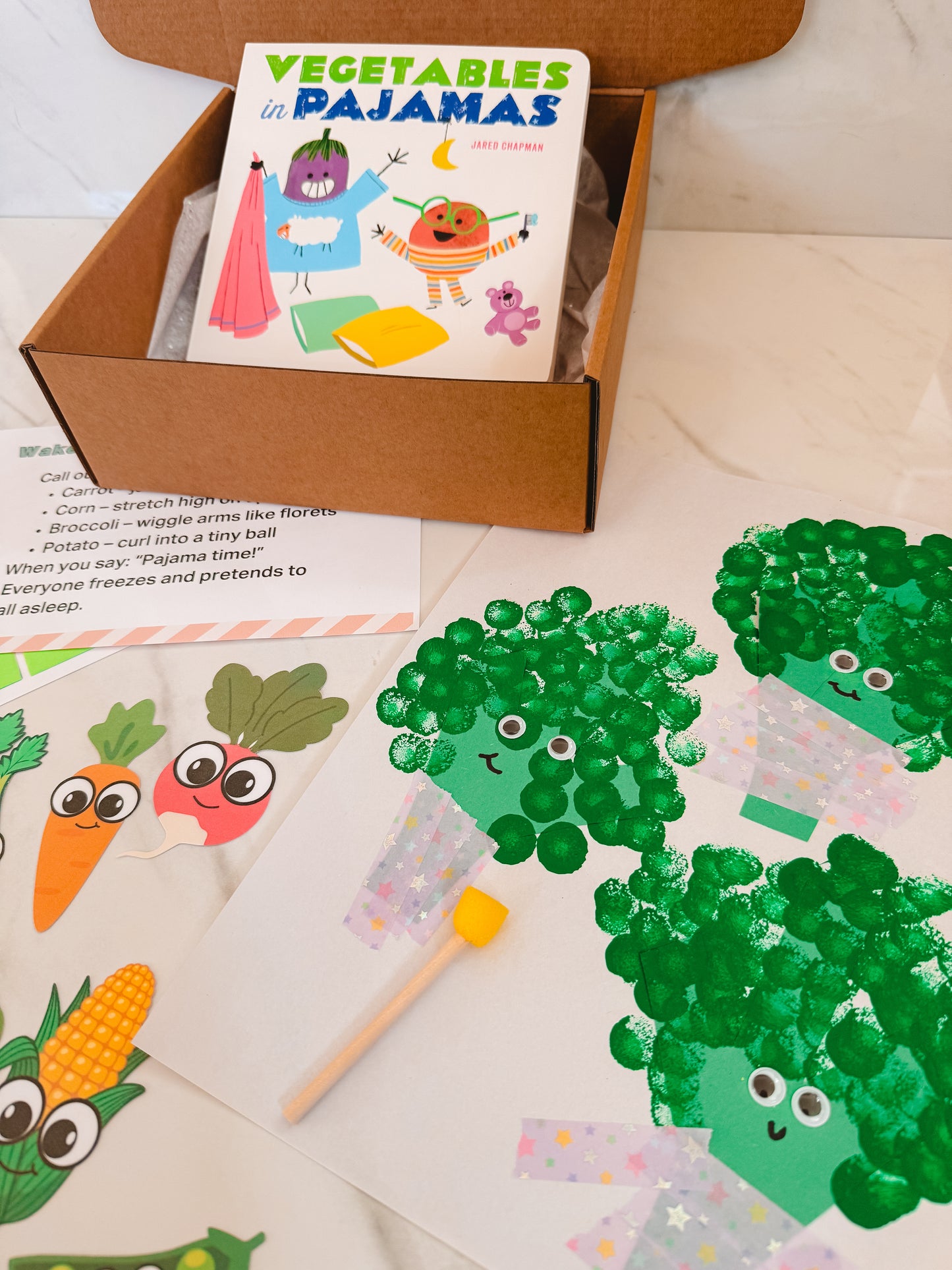 Children's book titled 'Vegetables in Pajamas' with a craft activity featuring broccoli and other vegetables.