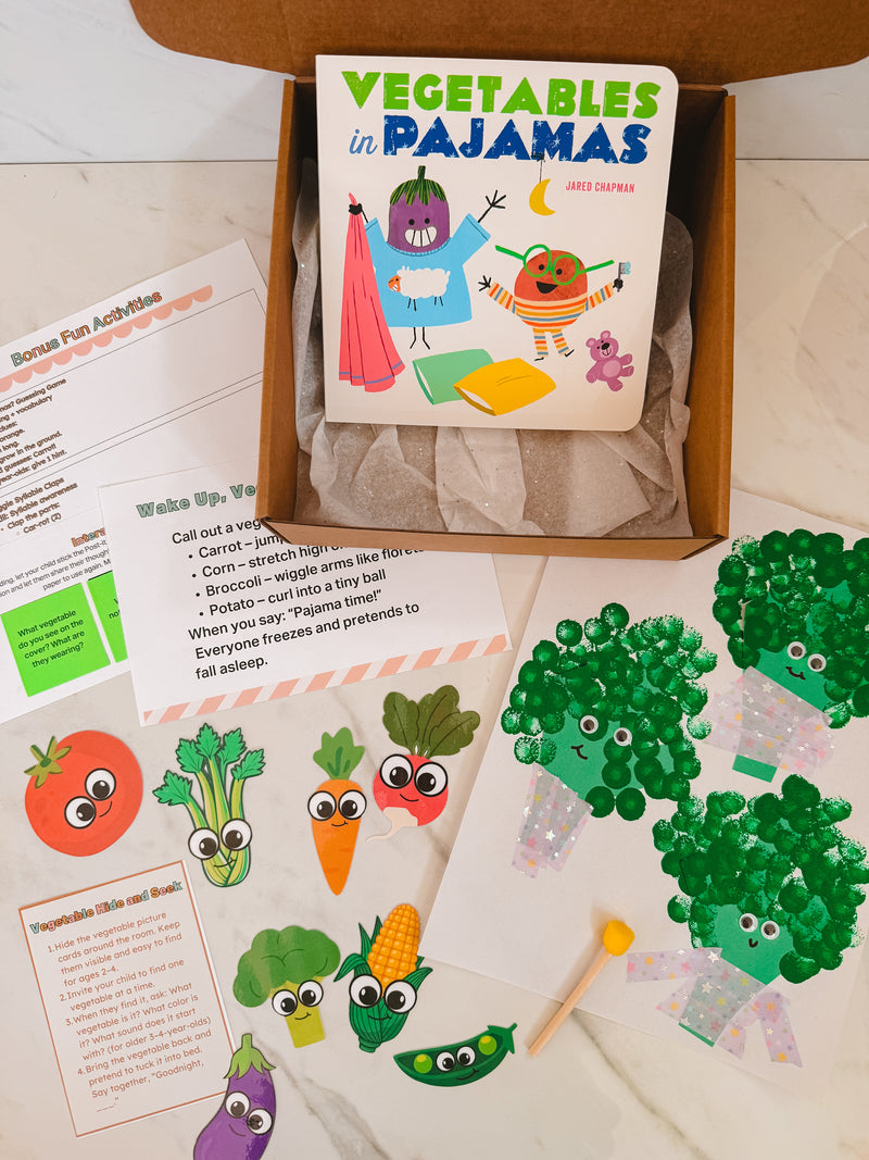 Children's book titled 'Vegetables in Pajamas' with related activities and illustrations on a wooden surface.