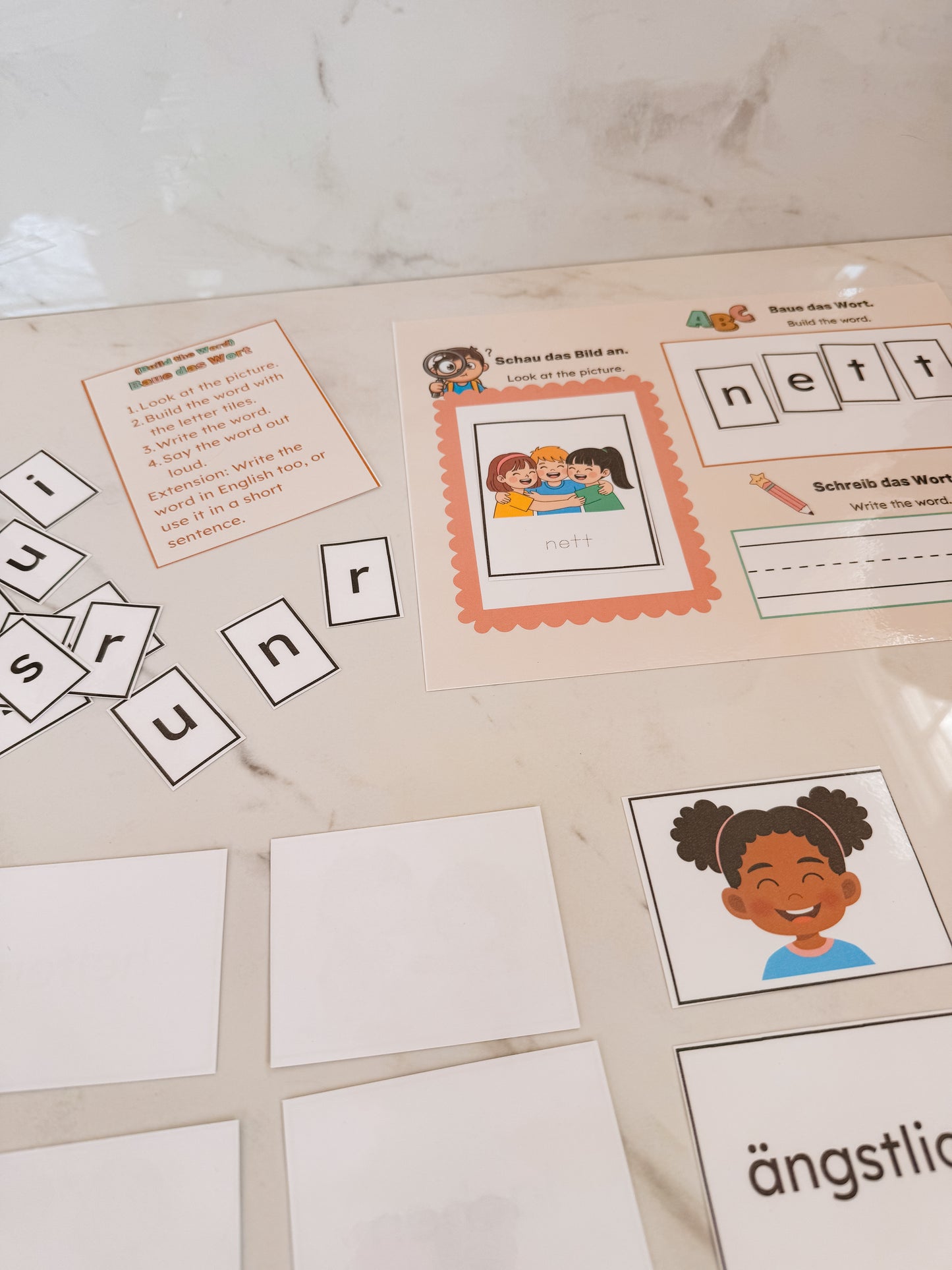Educational materials with letters and images on a marble surface